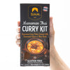 Siam Massaman Thai Curry Kit packaging held by a hand on a white background