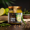 Jar of Siam Green Thai Curry Paste with ingredients on a wooden surface