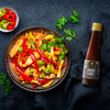 Bowl of SIAM Oyster stir-fried vegetables with oyster sauce on a dark surface